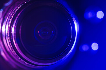 Camera lens with purple and blue backlight. Optics. Cyberpunk style