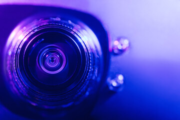 .Camera lens with purple and blue backlight. Optics