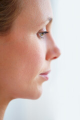 Uncertain of her future. Pensive mature woman looking away - profile view.