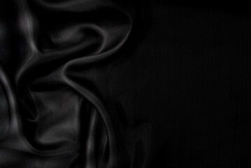 Part of the dark fabric texture of the fabric for the background and decoration of the work of art, a beautiful crumpled pattern of silk or linen. A crumpled piece of cloth