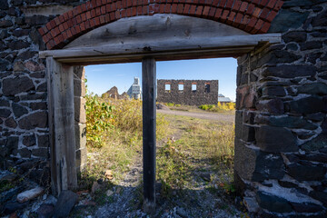 Looking at the Quincy Mine through an abandoned doorway from a building ruin
