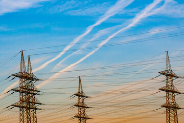 electrical tower in landscape with blue sky in sunrise