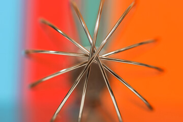 Extreme close up shot of Egg beater wires on colorful background, selective focus