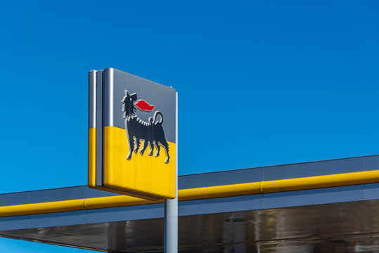 Fossano, Italy - February 22, 2022: Eni logo sign of fuel service station on blue sky, Eni S.p.a is an Italian oil company worldwide. Expensive fuel price concept.