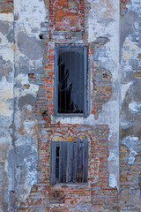 Bright, vivid and colorful background or texture of ancient building or edifice facade or front with windows covered with net