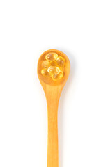 Vitamin D 3 supplement on a spoon isolate on a white background. Selective focus.