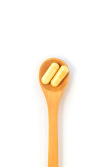 Pills on a spoon isolate on a white background. Selective focus.