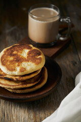 Tortilla de maiz a traditional Ecuadorian appetizer served with coffee. It’s on a wooden background. 