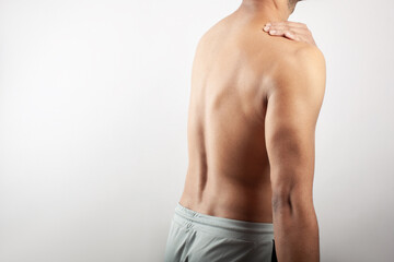 fitness male body suffering from trapezius muscle soreness, shoulder muscle pain