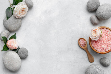 Obraz na płótnie Canvas Spa stones for massage with roses and sea salt, top view