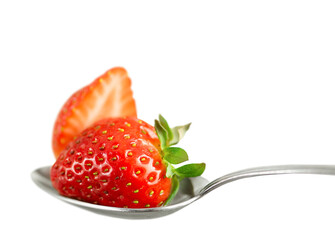 Strawberries in a spoon isolated on a white background.