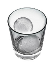 Side view in black and white of a tapered glass with two round ice cubes