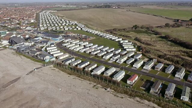 Aerial footage along the south coast by Bracklesham Bay and the holiday resort caravan park village near East Wittering in West Sussex, Southern England.