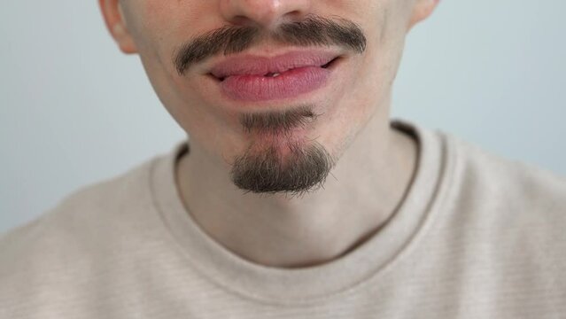Caucasian young man adjusting and placing an invisible silicone aligner for dental correction. Male hand holding the plastic braces dentistry retainers to straighten teeth