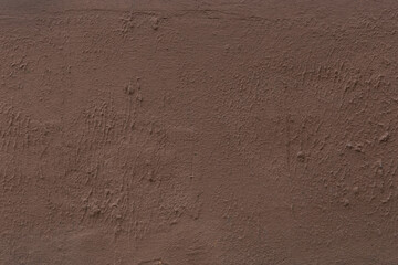 Brown dark coffee color plaster wall abstract coarse surface rough texture stucco background