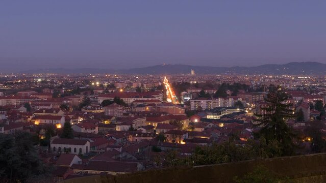 Rivoli, Italy. Night view from above of the town of Rivoli and the city of Turin. Day-to-night timelapse video.