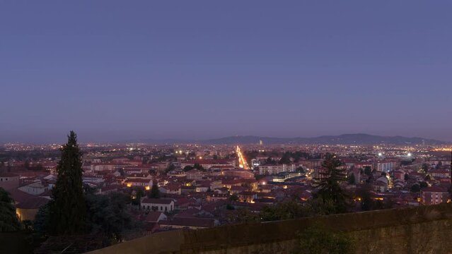 Rivoli, Italy. Night view from above of the town of Rivoli and the city of Turin. Day-to-night timelapse video.