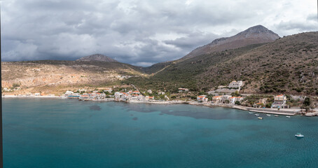 Greece, Mani New Oitylo seaside fishing village under cloudy sky, aerial view. Peloponnese. Laconia