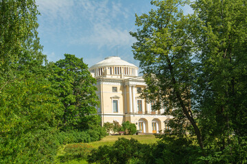 The view of the 18th century Pavlovsk Imperial Palace built by the order of Catherine the Great from the green alley in Pavlovsk, Russia