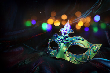 Photo of elegant and delicate Venetian mask over dark background