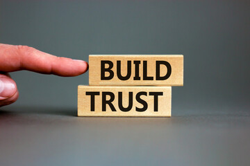 Build trust symbol. Concept words Build trust on wooden blocks on a beautiful grey table grey...