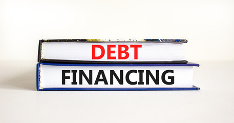 Debt financing symbol. Concept words Debt financing on books on a beautiful white table white background. Business finance and debt financing concept, copy space.