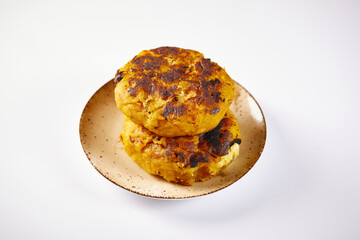 Tortilla de platano a traditional Ecuadorian appetizer. It’s on a white background.