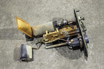 Old dirty rusty fuel pump on a gray background close-up. Car parts