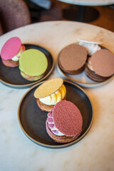 Colourful danish fastelavnsbolle with jam, whipped cream and almond paste in laminated pastry dough with powdered sugar on top served in Copenhagen, Denmark in a cafe bakery Andersen Bakery