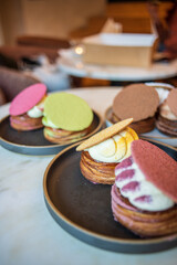 Colourful danish fastelavnsbolle with jam, whipped cream and almond paste in laminated pastry dough with powdered sugar on top served in Copenhagen, Denmark in a cafe bakery Andersen Bakery