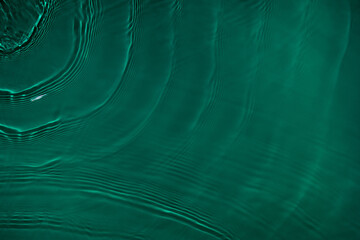 Transparent dark green clear water surface texture with ripples, splashes and bubbles. Abstract...