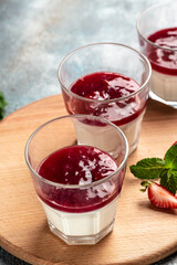 Italian dessert panna cotta with strawberry decorated with fresh berries. homemade dessert panna cotta. vertical image. top view. place for text