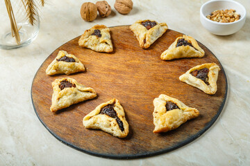 Gomentashi cookies traditional for the Jewish holiday of Purim on a wooden board.