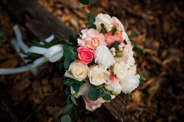 Golden wedding rings, beautiful bridal bouquet of flowers