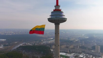 Giant tricolor Lithuanian flag waving on Vilnius television tower in Vilnius.