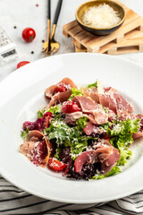 Salad with Prosciutto, ham and grapefruit jamon, salad mix, grapefruit, cherry tomatoes, parmesan cheese. Healthy food, keto diet, diet lunch concept