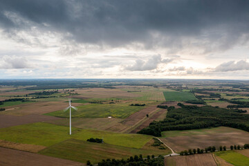 Going green with a wind power from a modern eco windmill turbine.