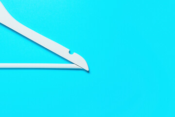 Clothes hanger on blue background