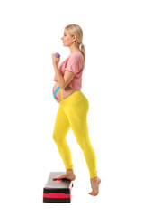 Pregnant woman with applied kinesio tape training against white background