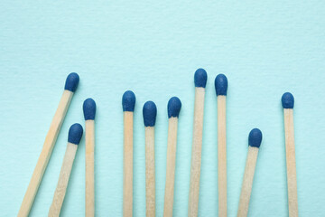 New matchsticks on blue background, closeup