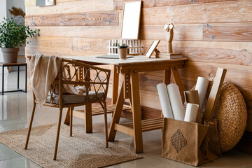 Interior of modern workplace with laptop and wicker chair