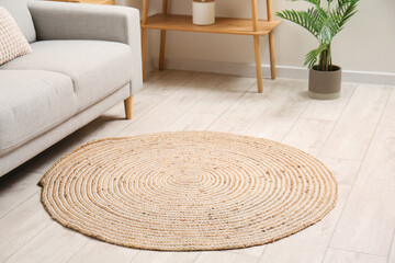 Trendy wicker carpet in stylish living room interior