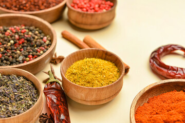 Bowls with aromatic spices on yellow background