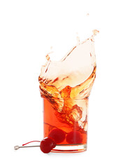Glass of tasty Manhattan cocktail with splashes isolated on white background