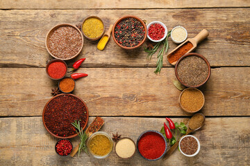 Frame made of aromatic spices on wooden background