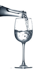 Pouring of clear water in glass isolated on white