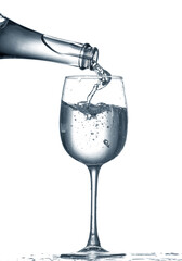 Pouring of clear water in glass isolated on white