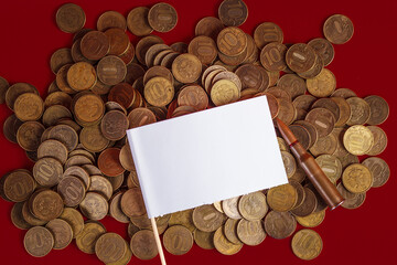 Live cartridge of a Kalashnikov assault rifle with an empty white flag on coins on a red...