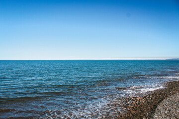 Seascape with clear blue sky and ocean water.