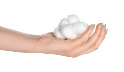 Female hand with cotton balls on white background, closeup